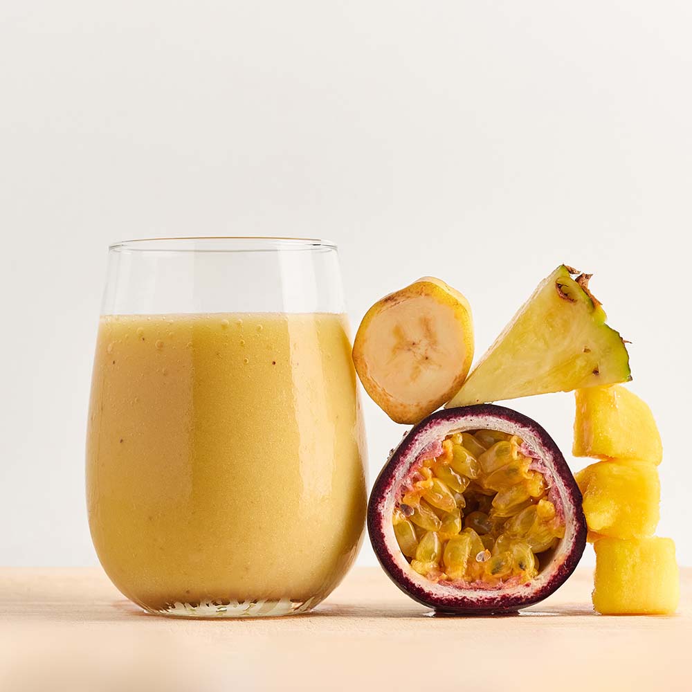 Healthy smoothie made with Reboot ready-to-blend pack and ingredients on table